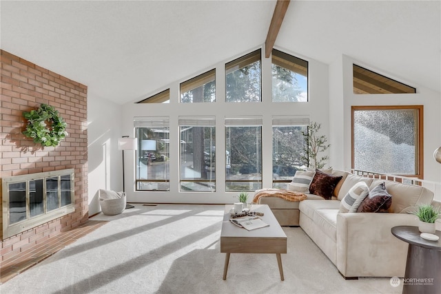 carpeted living room featuring a brick fireplace, beam ceiling, and high vaulted ceiling