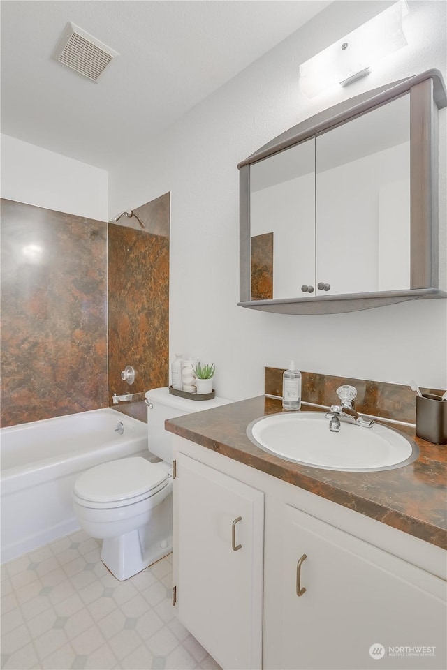 full bathroom with vanity, toilet, and tiled shower / bath