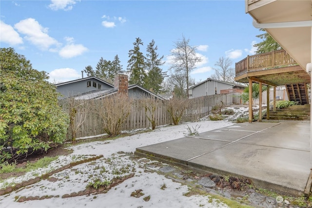 exterior space with a wooden deck and a patio