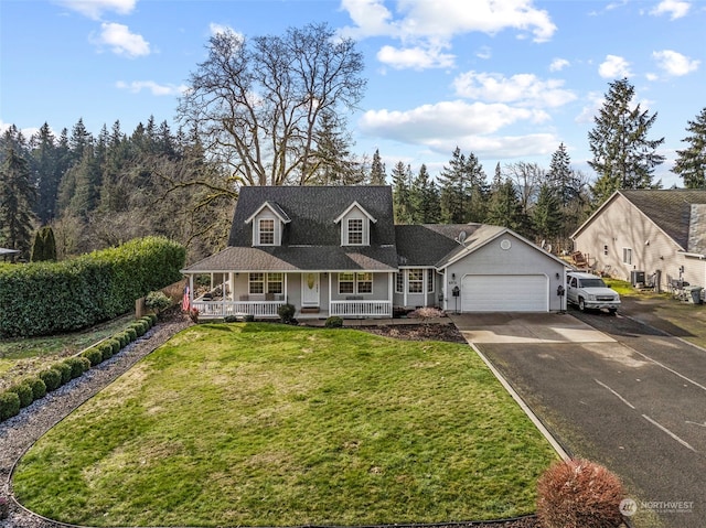 view of front of property featuring a garage, covered porch, and a front lawn