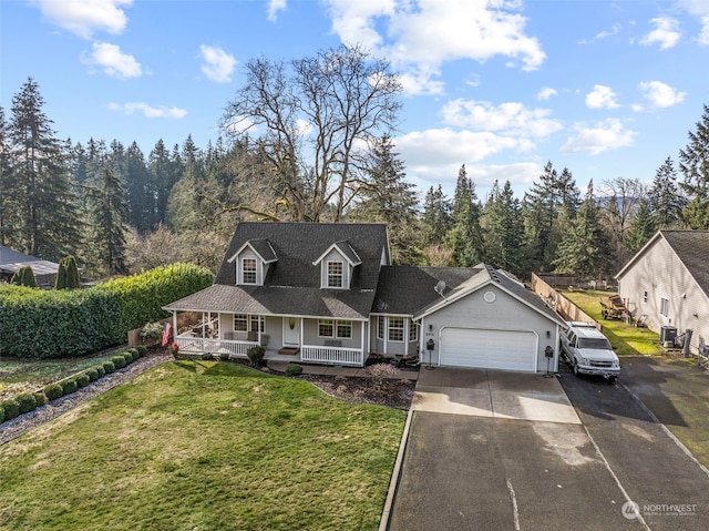 view of front of home with a porch, a garage, and a front lawn