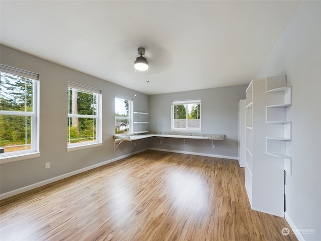 unfurnished room with light hardwood / wood-style flooring and ceiling fan