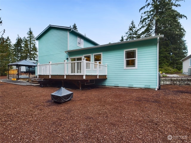 back of house featuring a gazebo, a wooden deck, and central air condition unit