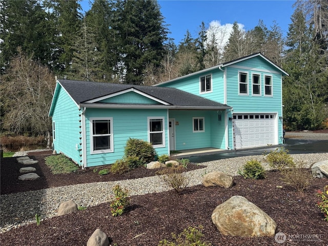 view of front of home featuring an attached garage, driveway, and roof with shingles