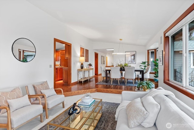 living room featuring lofted ceiling and wood finished floors