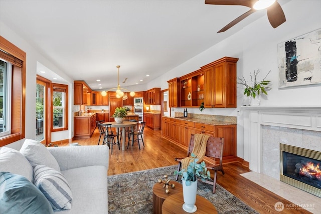 living room featuring a high end fireplace, light wood finished floors, and recessed lighting