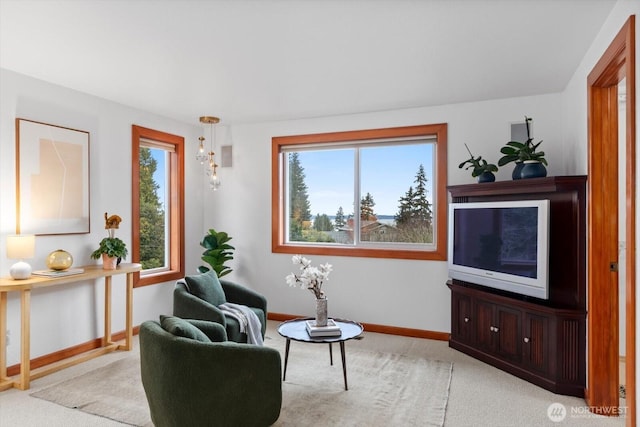 sitting room featuring carpet floors and baseboards