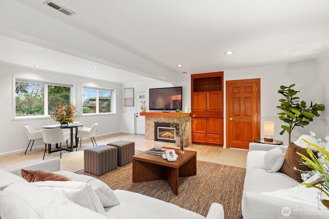 living area with visible vents, baseboards, a tile fireplace, carpet floors, and recessed lighting