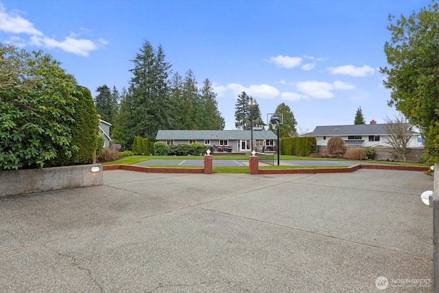 view of property's community with a yard and community basketball court