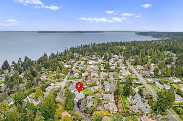 bird's eye view with a water view, a wooded view, and a residential view