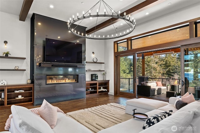 living room with dark wood-type flooring, a large fireplace, and beam ceiling