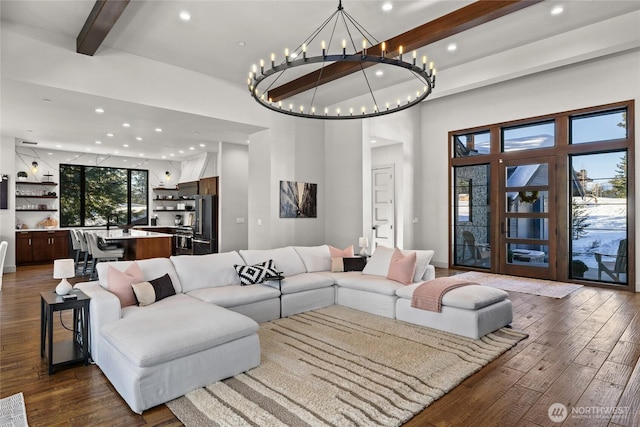 living room with a towering ceiling, dark wood-type flooring, and beamed ceiling