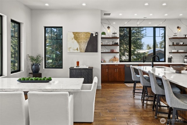 dining space featuring sink and dark hardwood / wood-style flooring