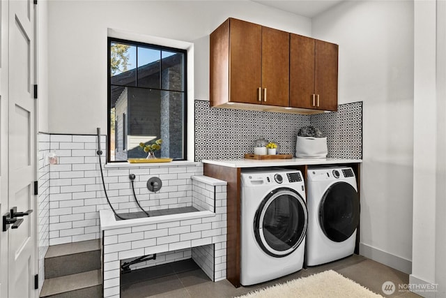 washroom with cabinets and independent washer and dryer