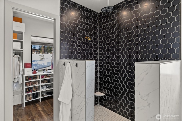 bathroom featuring wood-type flooring and tiled shower