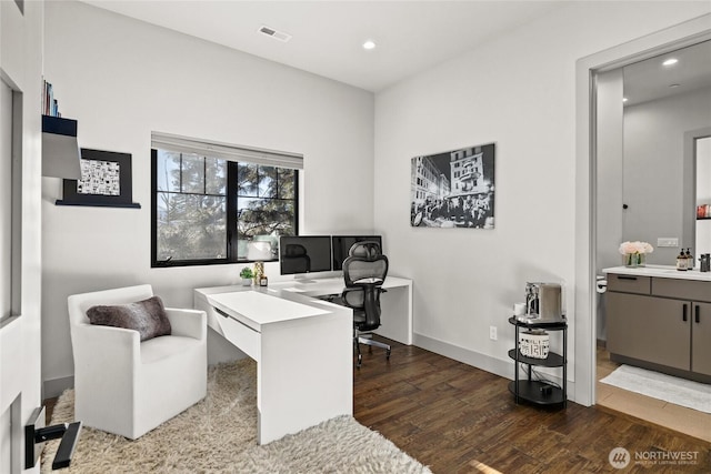 office featuring dark wood-type flooring and sink