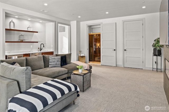 living room with light colored carpet and wet bar