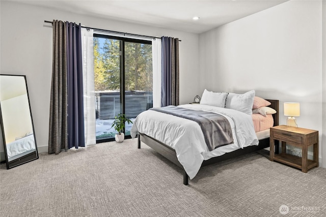 bedroom featuring light carpet and access to outside