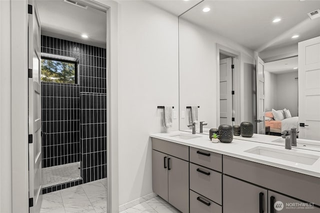 bathroom featuring vanity and a tile shower