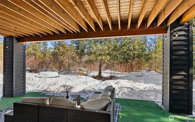 snow covered patio featuring an outdoor living space