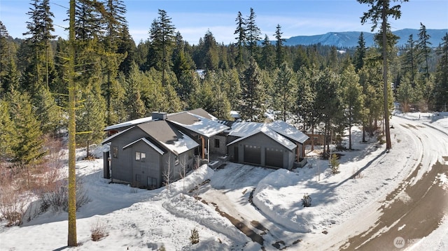 snowy aerial view featuring a mountain view