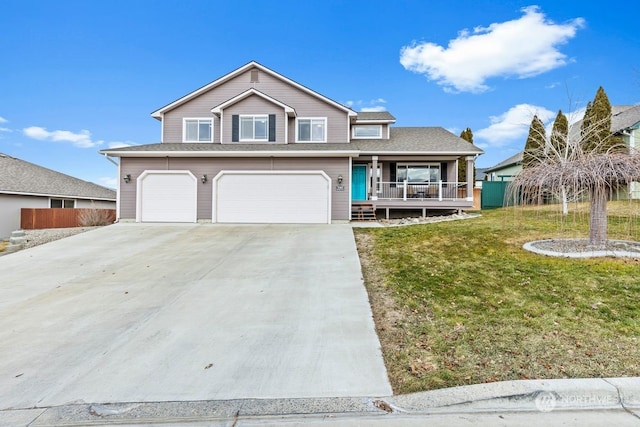 view of front of home with a garage, covered porch, and a front lawn