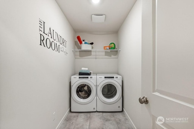 clothes washing area featuring washer and dryer