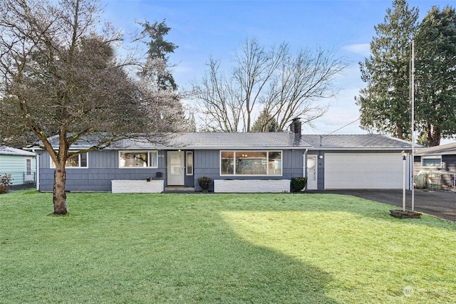 ranch-style home featuring a garage and a front yard