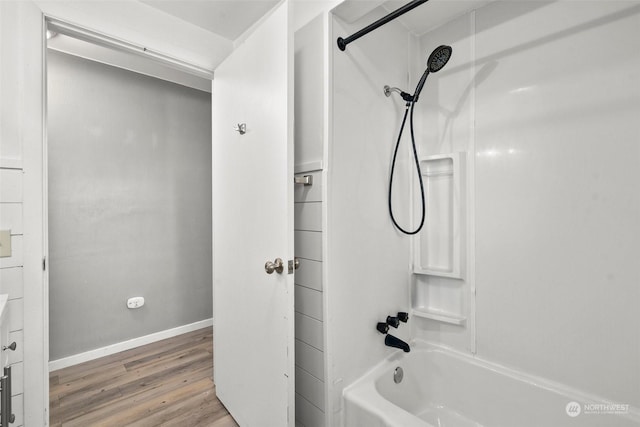 bathroom featuring hardwood / wood-style flooring and shower / tub combination