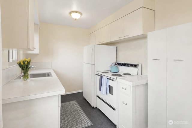 kitchen with sink, white appliances, and white cabinetry