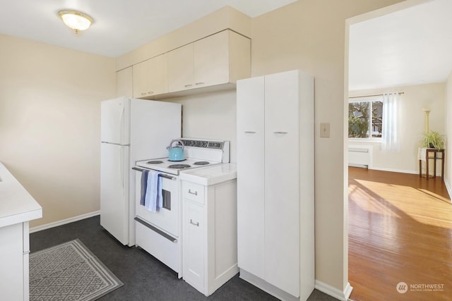 kitchen with white cabinetry and white appliances