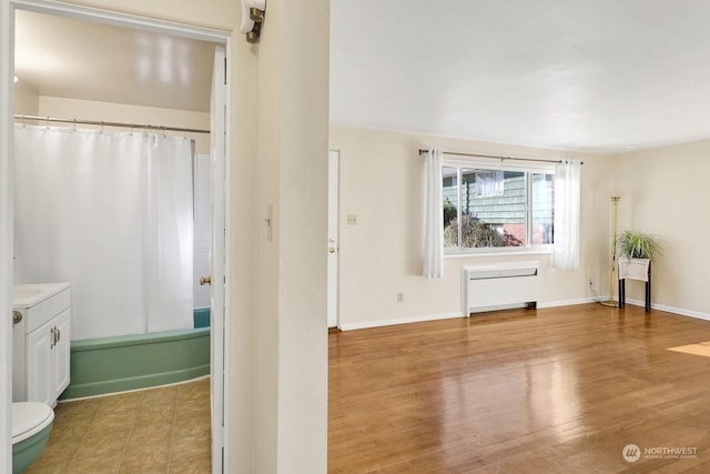 full bathroom with toilet, vanity, wood-type flooring, and shower / bath combo with shower curtain