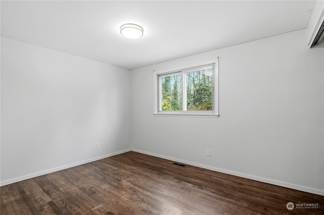 spare room with dark hardwood / wood-style flooring