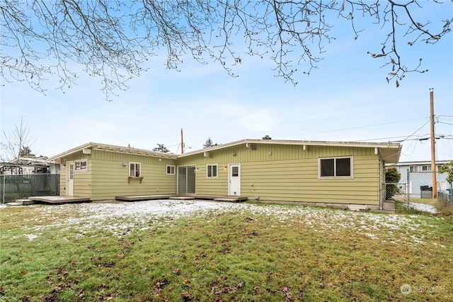 back of property featuring a yard and a deck