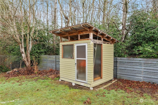 view of outbuilding with a yard