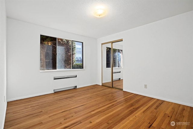 empty room with hardwood / wood-style flooring