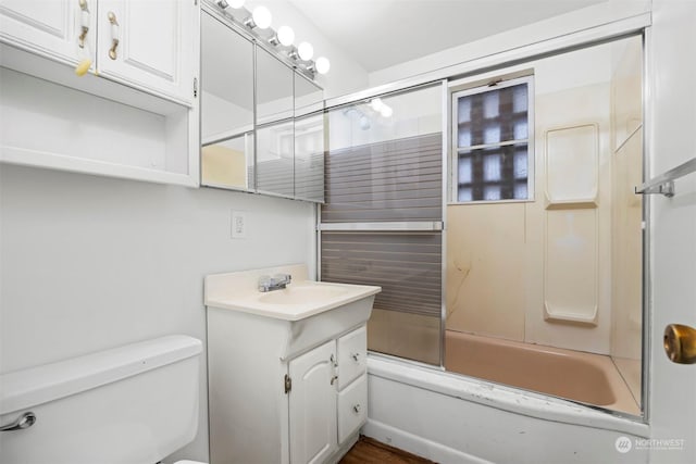 full bathroom with vanity, combined bath / shower with glass door, and toilet