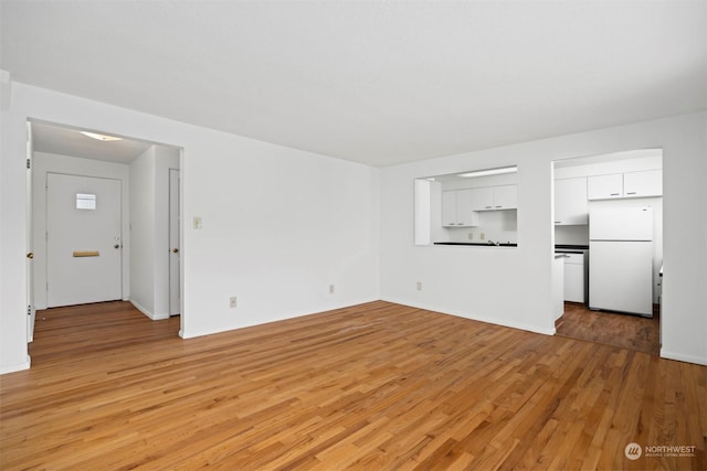 unfurnished living room with light wood-type flooring