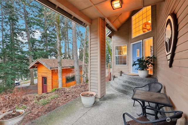 view of patio featuring a storage unit