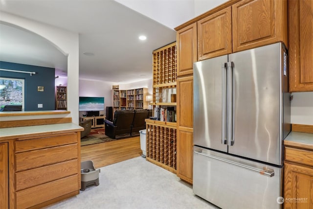 kitchen featuring high quality fridge and light hardwood / wood-style floors