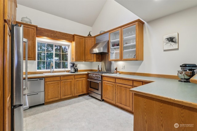 kitchen with vaulted ceiling, sink, kitchen peninsula, stainless steel appliances, and wall chimney exhaust hood