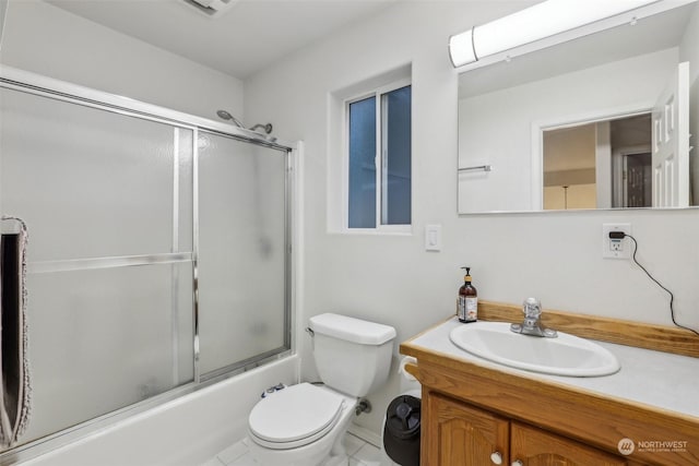 full bathroom featuring vanity, toilet, and combined bath / shower with glass door