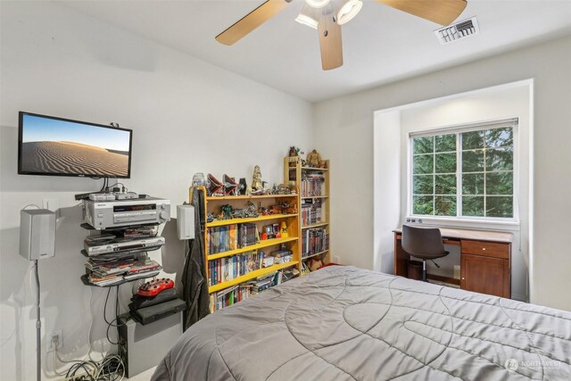 bedroom with ceiling fan and built in desk