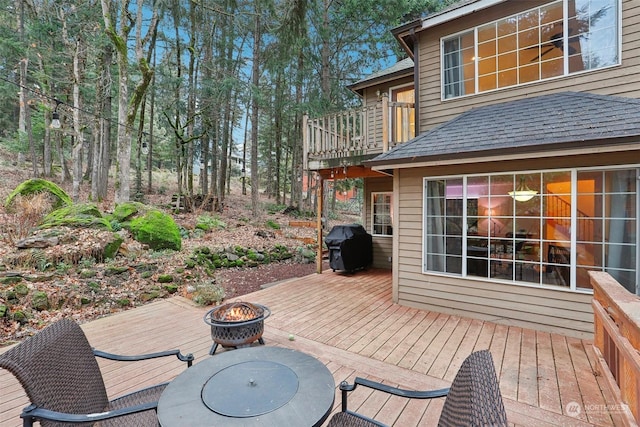 deck featuring a grill and a fire pit