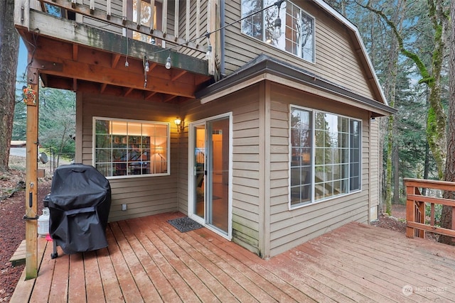 wooden terrace featuring a grill