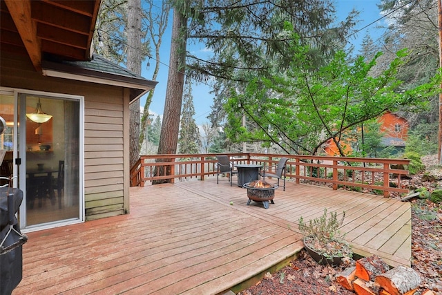 wooden terrace featuring a fire pit