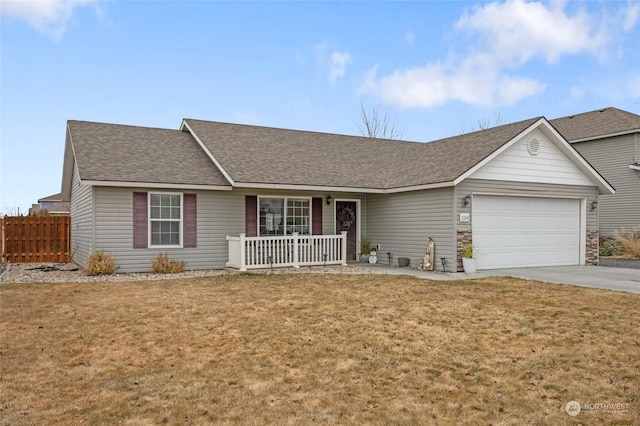 ranch-style house featuring a garage, a front lawn, and a porch