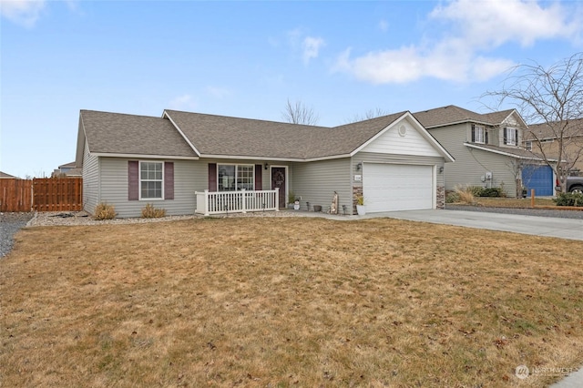 ranch-style house featuring a garage, a porch, and a front yard