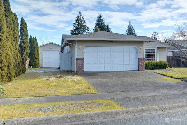 single story home featuring a garage and a front lawn