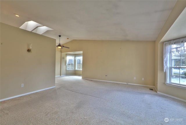 carpeted empty room featuring ceiling fan and lofted ceiling